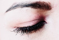 a close up of a woman's eye with long lashes