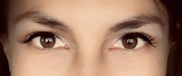 a close up of a woman's eyes