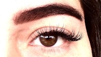 a close up of a woman's eye with long lashes